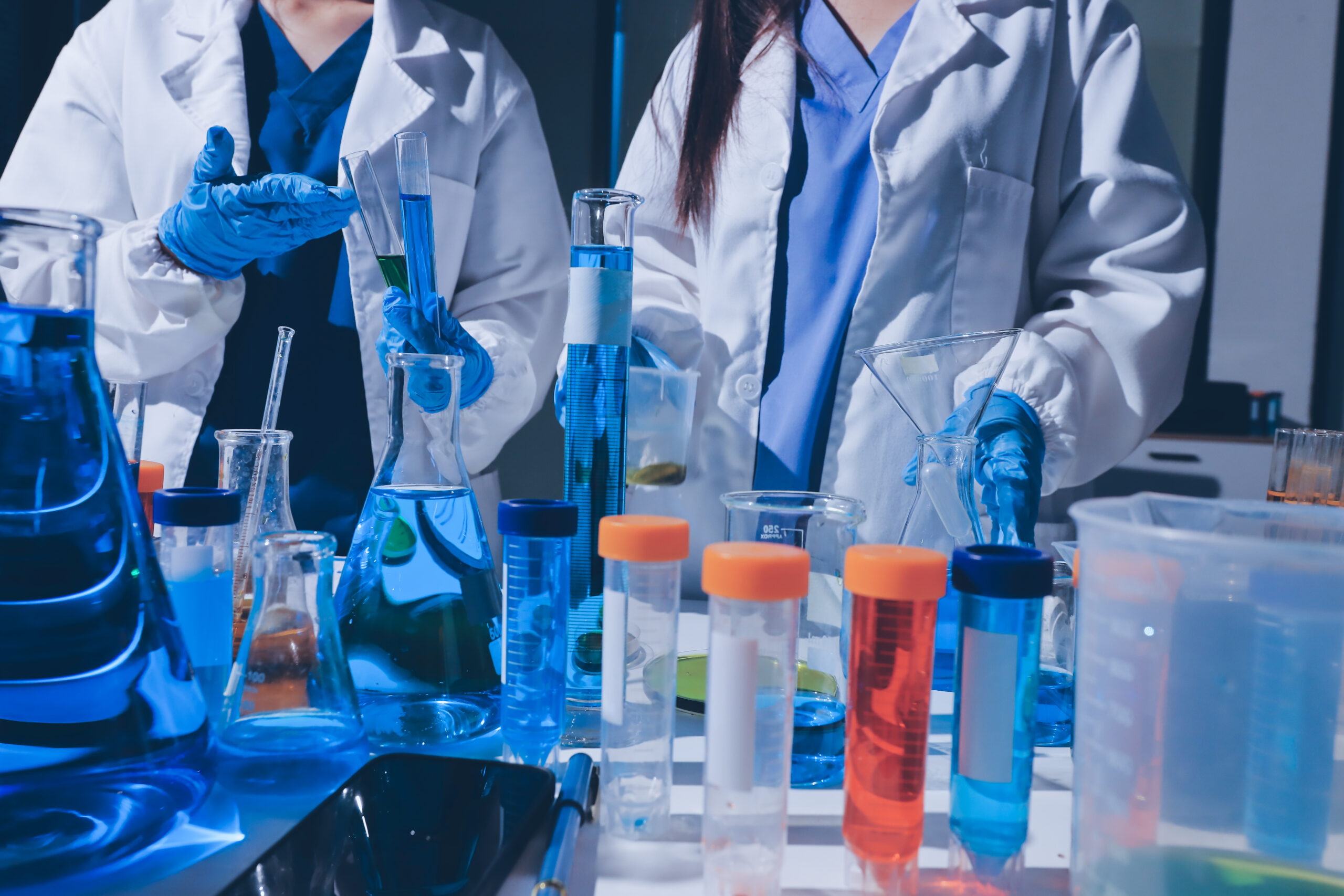 scientist pipetting medical samples into microplate in laborator