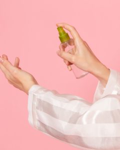 vue-de-face-de-la-femme-a-l-aide-de-spray-pour-le-traitement-de-la-peau